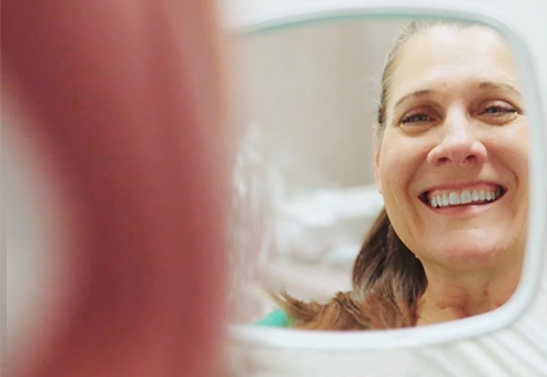 Happy patient after her visit and veneer treatment at Dental Expressions