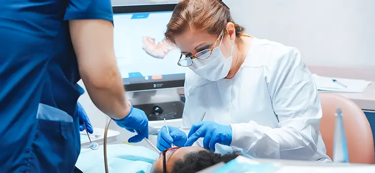 Dentist performing a simple tooth extraction